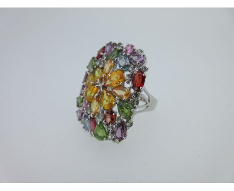the pierced convex panel of rectangular cushion shape set with a central sunburst of pear and marquise cut orange sapphires, 