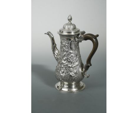 by Francis Crump, London 1769, of baluster form and decorated with repoussé scrolls and foliage over a textured ground around