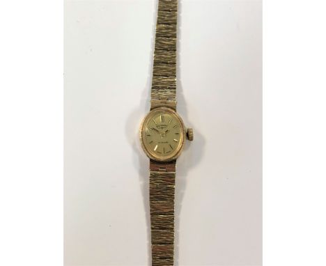 c1973, the signed oval champagne dial with gold lined batons and hands, 21 jewel mechanical crown wind movement with company 