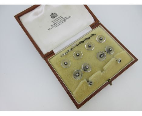 composed of double-ended cufflinks, four shirt studs and two collar studs, each element designed as a concave frosted disc of
