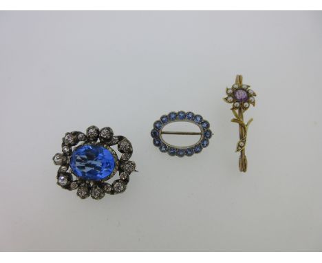 the first an oval petal edged hoop of uniform round cut vivid light blue sapphires, length 2.2cm; the second an antique ameth