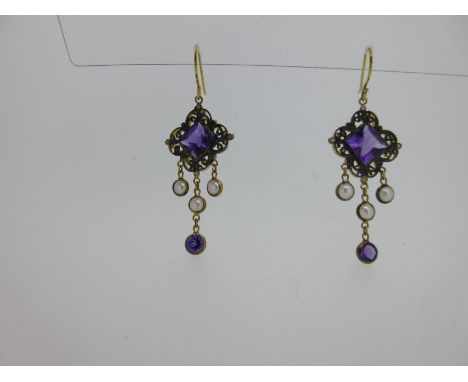each hook suspending a large square step cut amethyst in a filigree diaper figure, with a diamond point at each corner, and s