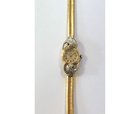 c1950, the signed cream coloured dial, 12mm diameter, with gold coloured alternate Arabic numerals and baton markers applied 