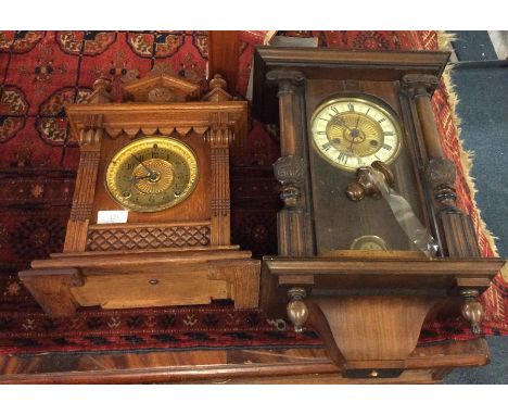 An oak mantle clock together with one other,