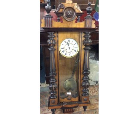 A walnut and mahogany wall clock.