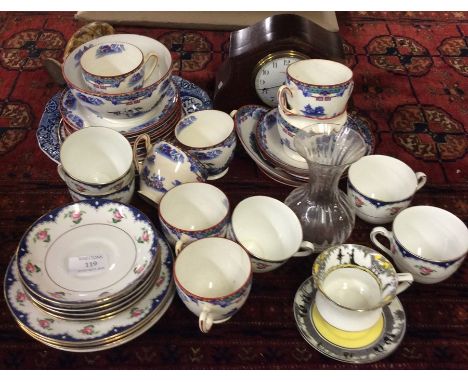 Decorative tea ware together with a mantle clock.