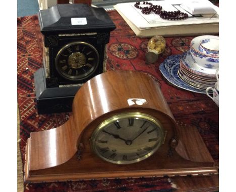 A slate mantle clock together with one other.