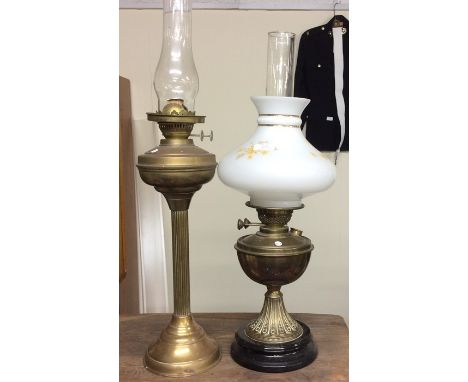 An old brass oil lamp together with one other.