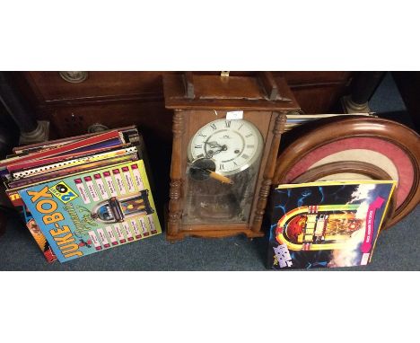 A quantity of records pictures and a wall clock.