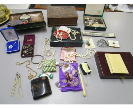 A quantity of costume jewellery, badges, pearl and faux pearl necklaces, vintage leather boxes and other items to include a 9