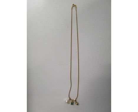 An Italian 9ct gold chain necklace with 18ct gold set emerald pendant, yellow metal set and paste white stone pendant, and ye