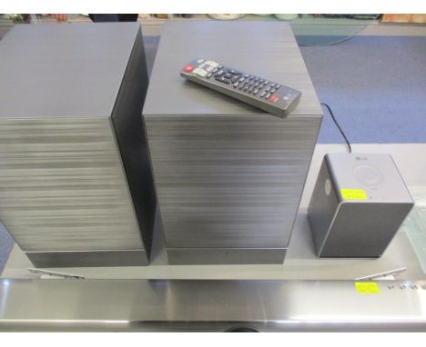 A pair of LG CE0197 brushed silver coloured speakers, an LG Bluetooth speaker and remote 