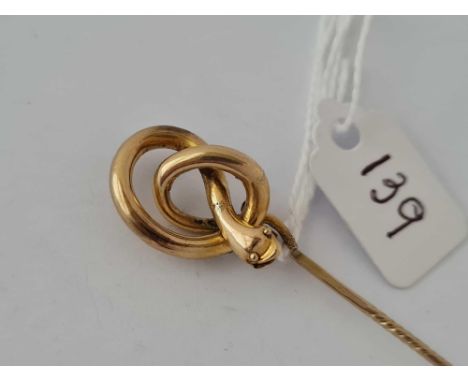 A large swirled snake stock/stick pin in high carat gold