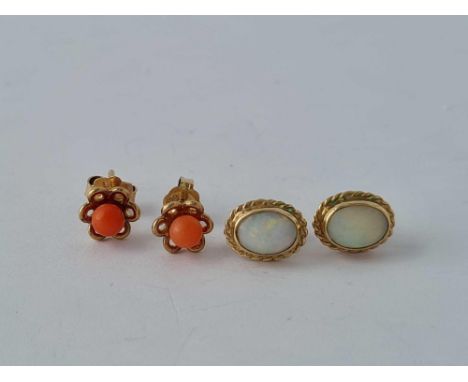 A pair of gold and opal earrings and a pair of gold &amp; coral studs