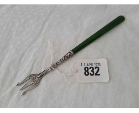 An antique pickle fork with three prongs, stamped STERLG silver with nephite handle