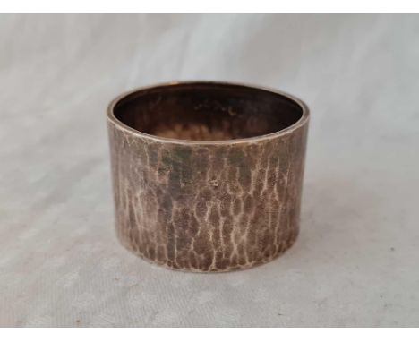 A Liberty &amp; Co napkin ring with hammered finish, Birmingham 1924