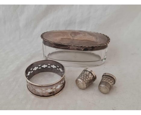 An oval jar, two thimbles and a napkin ring