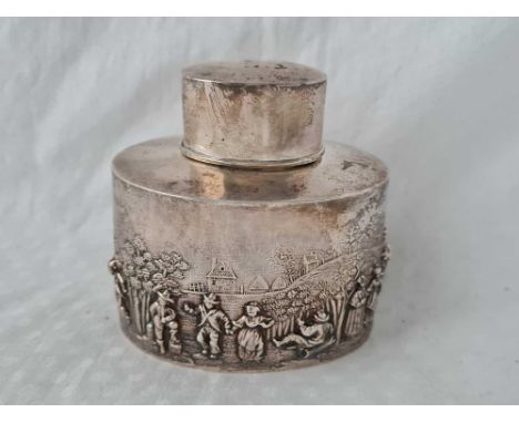 A decorative tea caddy with pull off cover and embossed with dancing figures, 3 1/4" wide, Birmingham 1902 by CH