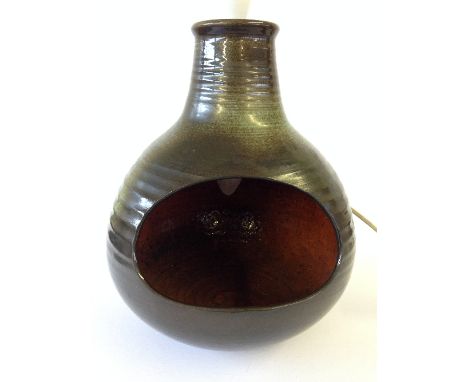 A Guy Sydenham Poole Pottery Atlantis period black clay bodied lamp base with orange glazed interior, the exterior decorated 