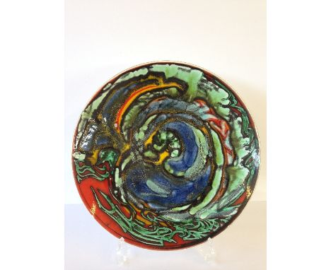 A Poole Pottery dish, shape 5, decorated in an abstract design in vivid colours by Josephine Wall.