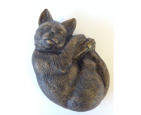 A Poole Pottery stoneware model of a Sleeping Cat.