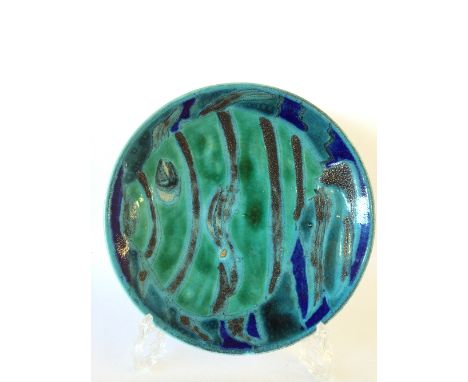 A Poole Pottery studio dish, decorated in a Fish design in tones of blue and green by Margaret Anderson (firing flaw) (8 inch