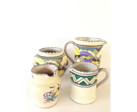 A Poole Pottery red bodied jug, decorated in the B Simple Grape pattern by Ethel Barrett (4.75 inches) together with two smal
