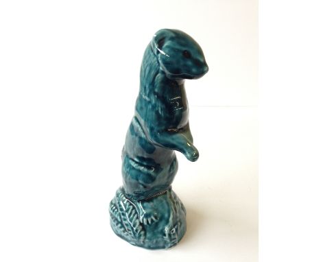 A Poole Pottery blue glazed model of a standing otter.