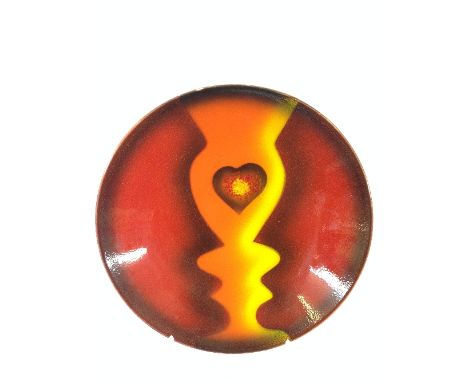 A Poole Pottery Living Glaze dish by Uri Geller, decorated in the Lovers Silhouette design depicting two stylised faces and a