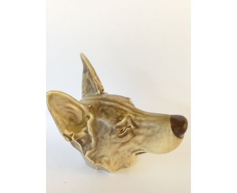 A Poole Pottery wall mounted model of a dog's head after a design by Harold Brownsword, modelled as an Alsatian. 