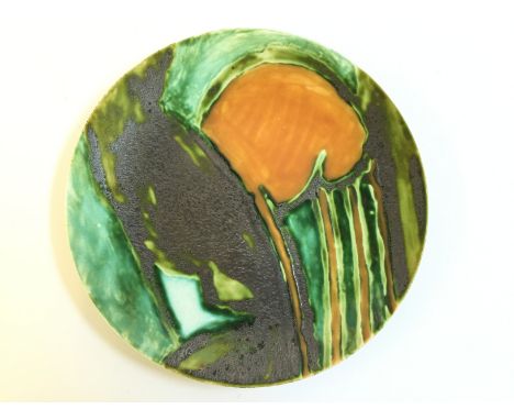 An unmarked and unglazed Studio plate attributed to Poole decorated in an abstract design in the style of Poole artists at th
