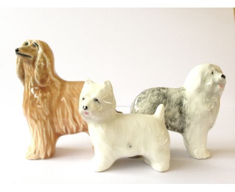 Three various Poole Pottery dog ornaments: Afghan Hound, Terrier and English Sheep dog.