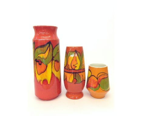 A Poole Pottery Delphis vase, shape 93, decorated in an abstract pattern on orange ground together with two others.