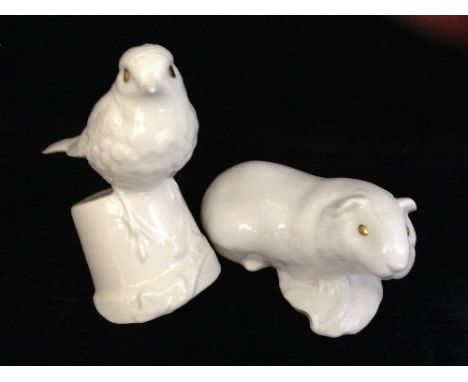 A Poole Pottery white bone china of a robin on a flower pot together with guinea pig with gold painted eyes.