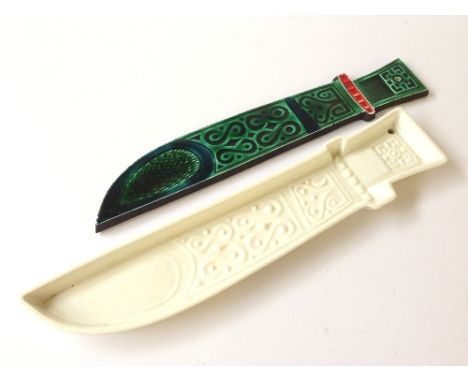 A white glazed Poole Pottery Robert Jefferson dagger dish together with a green and red glazed dagger plaque.