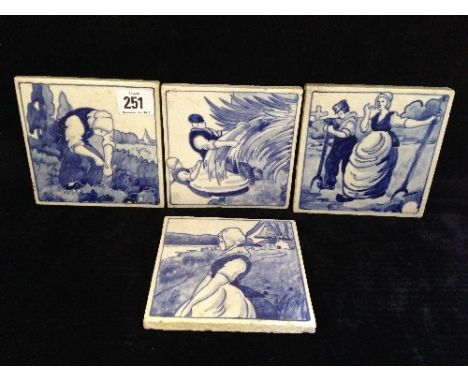 A set of four early 20th century Poole Pottery blue and white tiles decorated in Dutch scenes designed by Joseph Roelants.