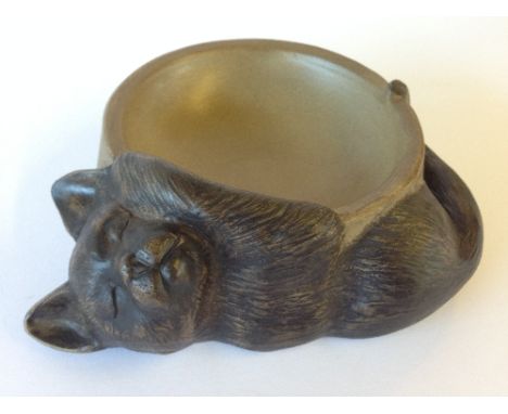 A Poole Pottery stoneware cat bowl decorated to the outside with a model of a sleeping cat.