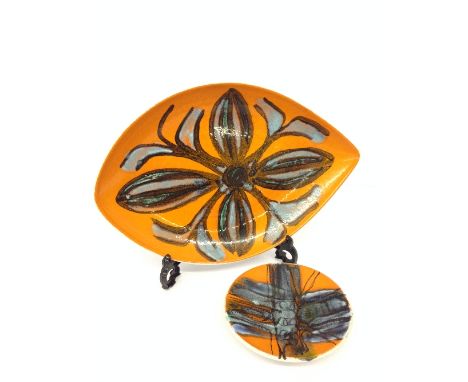 A Poole Pottery Delphis dish, shape 45, decorated in an abstract floral pattern on orange ground by Janet Laird together with