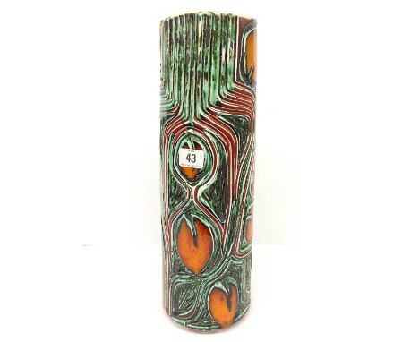 A tall Poole Pottery carved Delphis cylindrical vase, shape 85, decorated in an abstract pattern in tones of orange and green