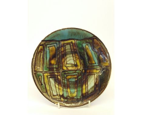 A Poole Pottery Studio dish decorated in an abstract pattern in tones of green, brown and yellow (8 inches diameter)(Mark No.