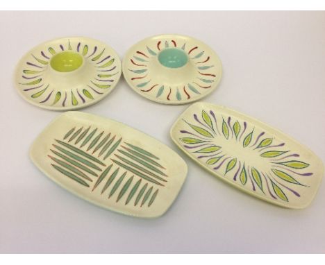 Two Poole Pottery Freeform small trays decorated in the UFW and UPT designs together with two egg cups decorated in the UFT a