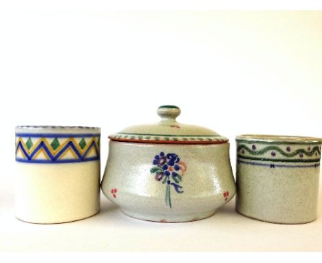 A red bodied Poole Pottery lidded pot, shape 497, decorated in the FJ pattern by Myrtle Bond together with two lidless pots.
