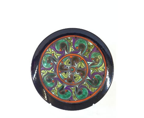 A Poole Pottery Ionian dish, decorated in an Art Nouveau style pattern in enamel colours by Carolyn Wills.