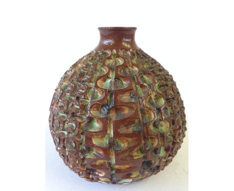 A Poole Pottery Atlantis carved squat vase by Beatrice Bolton, decorated in tones of green and brown.