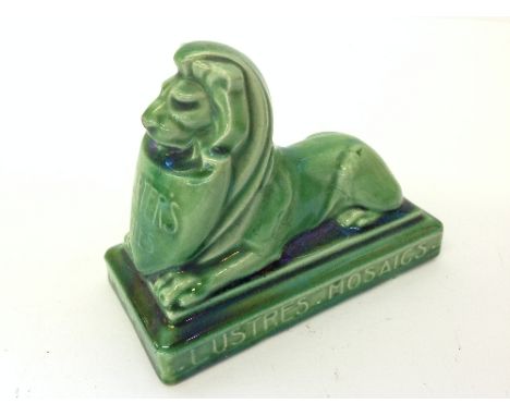 An early 20th century Poole Pottery Carters Tiles green glazed lion paperweight inscribed Terra-Cotta. Faience. Lustre's. Mos