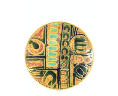 A Poole Pottery Delphis Studio dish, decorated in an abstract pattern in tones of green, yellow and blue.
