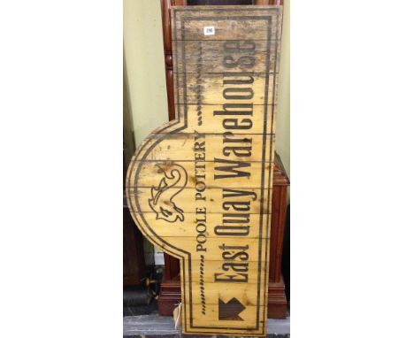 A large wooden sign originally installed at the Poole Pottery premises in the Quay advertising the East Quay Warehouse. Measu