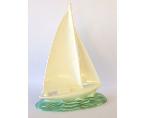 A Poole Pottery 1920's model of a Racing Yacht, designed by John Adams, shape 814/3 (10 inches).