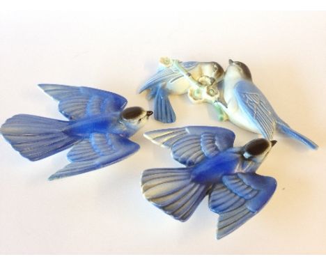 A Poole Pottery wall mounted model of a Pair of Lovebirds (tail restored) together with a pair of Flying Bluebirds.