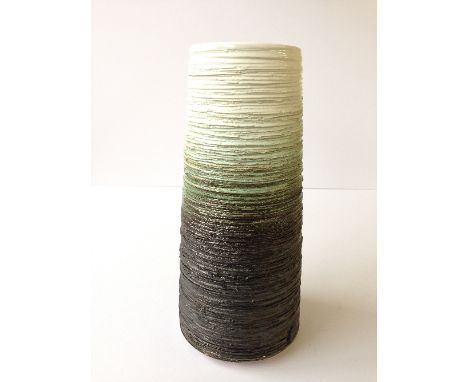 A modern Poole Studio volcano shape carved vase by Alan White decorated in tones of black, green and cream.